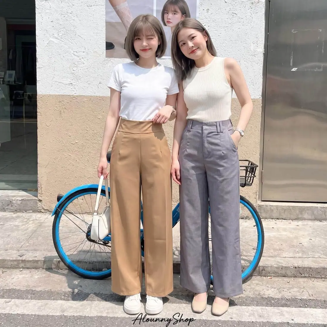 Two models in camel and grey high-waist straight-leg trousers